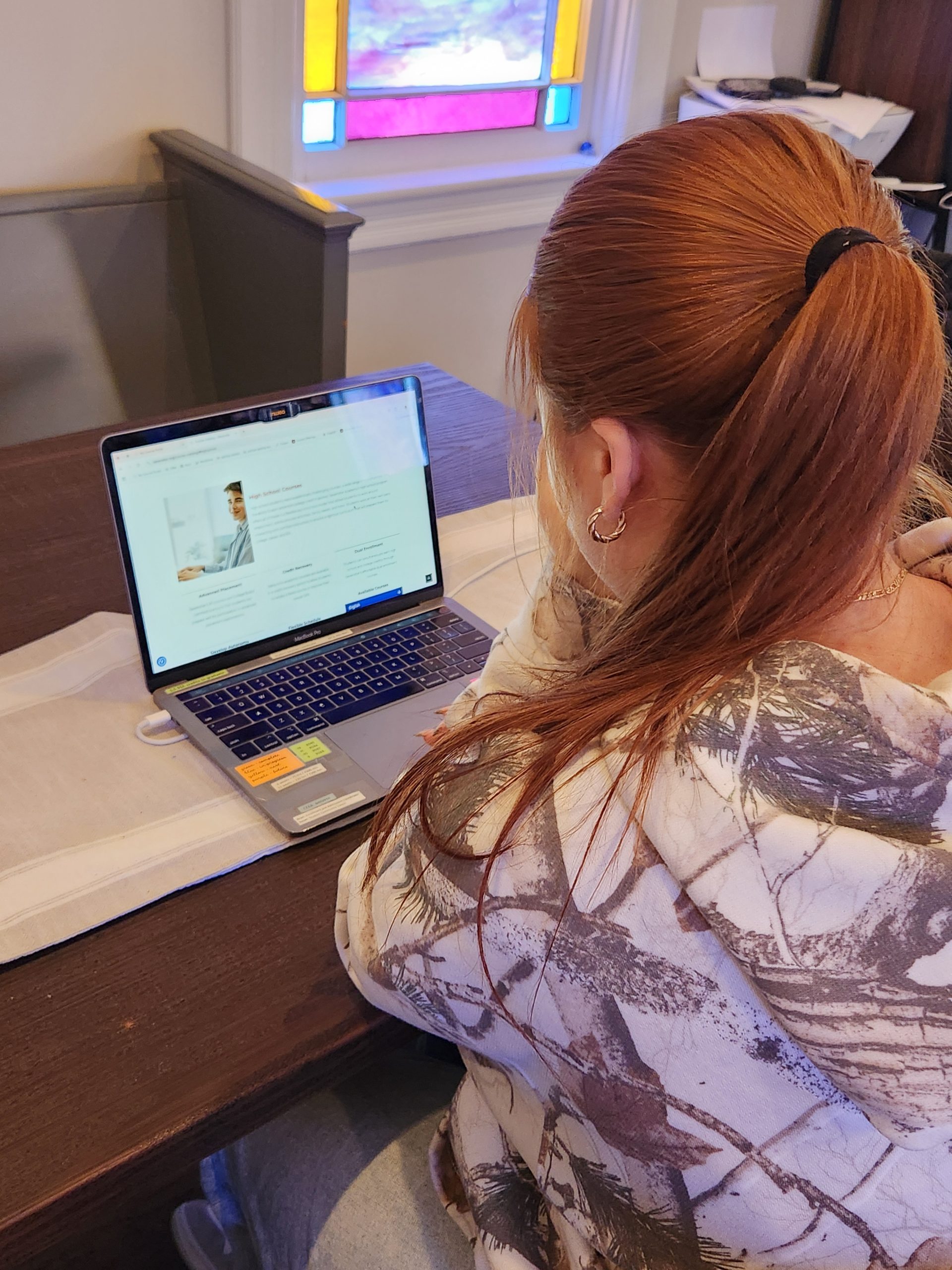 Student working on laptop at home.