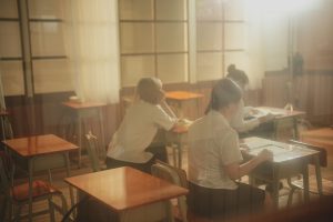 Students sitting at desk in classroom.