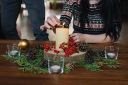Women lighting an advent candle at Christmas